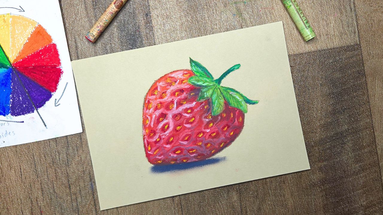 Dessin d'une fraise au pastel gras comparaison pastel sec et pastel gras